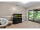 Basement featuring a large aquarium, sliding glass door, and access to the outside deck at 138 Ardmore Pl, Mooresville, NC 28117