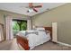 Cozy bedroom features a ceiling fan and sliding glass doors leading to a private outdoor space at 138 Ardmore Pl, Mooresville, NC 28117