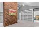 Bonus room features a red brick accent wall, a built-in bookcase, and contemporary lighting at 138 Ardmore Pl, Mooresville, NC 28117