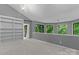 Spacious bonus room features a vaulted ceiling, a built-in bookcase, and large windows with backyard views at 138 Ardmore Pl, Mooresville, NC 28117