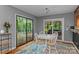 Dining area with views of the deck and backyard, featuring sliding doors and a modern chandelier at 138 Ardmore Pl, Mooresville, NC 28117