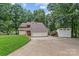Exterior of a two-story home with a two-car garage, long driveway, shed, and manicured lawn at 138 Ardmore Pl, Mooresville, NC 28117