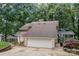 Attached garage with a paved driveway, mature trees, side yard and neutral paint at 138 Ardmore Pl, Mooresville, NC 28117