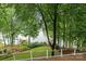 A scenic lake view from the deck surrounded by lush trees and landscaping, with a glimpse of neighboring docks at 138 Ardmore Pl, Mooresville, NC 28117
