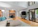 Cozy living room with a brick fireplace, hardwood floors, comfortable seating, and natural light at 138 Ardmore Pl, Mooresville, NC 28117