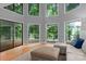 Living room with high ceilings, large windows offering scenic views, and comfortable seating area at 138 Ardmore Pl, Mooresville, NC 28117
