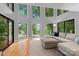 Living room with high ceilings, large windows offering scenic views, and comfortable seating area at 138 Ardmore Pl, Mooresville, NC 28117