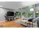 Bright living room featuring an entertainment center, large windows, access to the deck, and comfortable seating at 138 Ardmore Pl, Mooresville, NC 28117