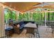 A screened-in porch with comfortable seating overlooking a lush backyard at 138 Ardmore Pl, Mooresville, NC 28117