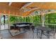 Screened-in porch showcasing stylish outdoor furniture, ceiling fan, and wooded views at 138 Ardmore Pl, Mooresville, NC 28117