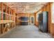 Unfinished basement with framed walls, open ceiling, storage and door to the backyard at 14746 Greenpoint Ln, Huntersville, NC 28078