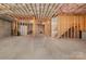 Unfinished basement with exposed ceiling insulation and framed walls, ready for customization at 14746 Greenpoint Ln, Huntersville, NC 28078