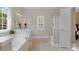 Bright bathroom featuring a soaking tub, a separate shower, and neutral tile flooring at 14746 Greenpoint Ln, Huntersville, NC 28078