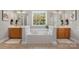 Luxurious bathroom featuring a soaking tub, double vanities, and tiled flooring at 14746 Greenpoint Ln, Huntersville, NC 28078