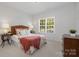 Cozy bedroom with natural light, a decorative headboard, and carpeted flooring at 14746 Greenpoint Ln, Huntersville, NC 28078