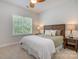 Comfortable bedroom with a ceiling fan, a decorative headboard, and bedside tables with lamps at 14746 Greenpoint Ln, Huntersville, NC 28078