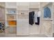 Spacious walk-in closet with custom shelving and storage options for clothing and accessories at 14746 Greenpoint Ln, Huntersville, NC 28078