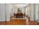 Elegant dining room with hardwood floors, chandelier, and view to the landscaped backyard at 14746 Greenpoint Ln, Huntersville, NC 28078