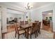Stylish dining area featuring hardwood floors, decorative columns, and views into the office and kitchen at 14746 Greenpoint Ln, Huntersville, NC 28078