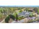 Aerial view of the golf course clubhouse, golf cart parking, and manicured greens at 14746 Greenpoint Ln, Huntersville, NC 28078