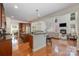 Open concept kitchen overlooking a living room and dining area, dark cabinets, hardwood floors at 14746 Greenpoint Ln, Huntersville, NC 28078
