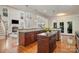 Open floor plan kitchen with wooden floors, stone countertops, and a view into the living room at 14746 Greenpoint Ln, Huntersville, NC 28078