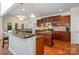 Spacious kitchen featuring dark wood cabinets, granite countertops and stainless steel appliances at 14746 Greenpoint Ln, Huntersville, NC 28078