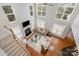 Bright, two-story living room with hardwood floors, a fireplace, and large windows at 14746 Greenpoint Ln, Huntersville, NC 28078