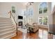 Inviting living room with soaring ceilings, large windows, fireplace, and hardwood floors at 14746 Greenpoint Ln, Huntersville, NC 28078