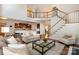 Open concept living room with staircase to the second floor, open to the kitchen, hardwood floors at 14746 Greenpoint Ln, Huntersville, NC 28078