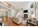 Spacious living room featuring a fireplace, staircase to the second floor, and hardwood floors at 14746 Greenpoint Ln, Huntersville, NC 28078