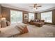Spacious main bedroom with a seating area, carpet, and ample natural light at 14746 Greenpoint Ln, Huntersville, NC 28078