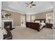Spacious main bedroom featuring a fireplace, tray ceiling, and neutral decor at 14746 Greenpoint Ln, Huntersville, NC 28078