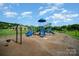 Community playground featuring swings, slides, and climbing structures with a pavilion in the background at 14746 Greenpoint Ln, Huntersville, NC 28078