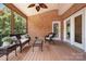 Cozy screened porch features wood ceiling and brick accent wall, furnished with wicker furniture at 14746 Greenpoint Ln, Huntersville, NC 28078