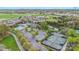 Aerial view of tennis courts, parking lot, and community pool surrounded by lush green trees and landscaping at 14746 Greenpoint Ln, Huntersville, NC 28078