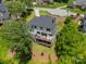 Aerial view of the back of the house featuring dual decks with ample seating surrounded by trees at 1543 Withers Dr, Denver, NC 28037