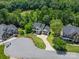 Aerial view of a modern farmhouse on a cul-de-sac surrounded by trees and well-kept lawns at 1543 Withers Dr, Denver, NC 28037