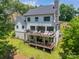 Expansive back of home featuring dual decks with seating areas and a well-maintained lawn at 1543 Withers Dr, Denver, NC 28037