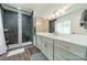 Modern bathroom features a walk-in shower and updated vanity with gray shaker cabinets at 1543 Withers Dr, Denver, NC 28037