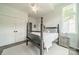 Well-lit bedroom with neutral colors, ceiling fan, and gray wood-frame bed, offering a bright and relaxing atmosphere at 1543 Withers Dr, Denver, NC 28037