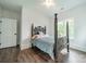 Bright bedroom features hardwood floors, ample natural light, and a gray wood-frame bed, creating a serene atmosphere at 1543 Withers Dr, Denver, NC 28037