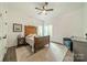 Cozy bedroom with elegant wooden bed frame, soft natural light, and comfortable seating, exuding warmth and relaxation at 1543 Withers Dr, Denver, NC 28037