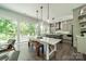 Bright dining area featuring a white table, modern lighting, and outdoor access to balcony at 1543 Withers Dr, Denver, NC 28037