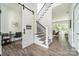 Bright foyer with hardwood floors, staircase, and a view of the living room at 1543 Withers Dr, Denver, NC 28037
