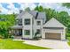 Beautiful two-story modern farmhouse with white siding, stone accents, and a two-car garage at 1543 Withers Dr, Denver, NC 28037
