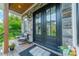 Charming front porch with stone accents, seating, and a stylish double-door entryway at 1543 Withers Dr, Denver, NC 28037