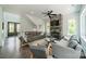 Inviting living room features a stone fireplace, ceiling fan, and lots of natural light at 1543 Withers Dr, Denver, NC 28037