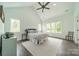 Light-filled main bedroom with hardwood floors, high ceilings, and multiple windows at 1543 Withers Dr, Denver, NC 28037