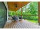 Charming covered porch with outdoor seating, offering a serene view of the lush, green surroundings, perfect for relaxation at 1543 Withers Dr, Denver, NC 28037